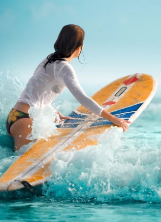 A surfer riding a wave, shot from low on the water