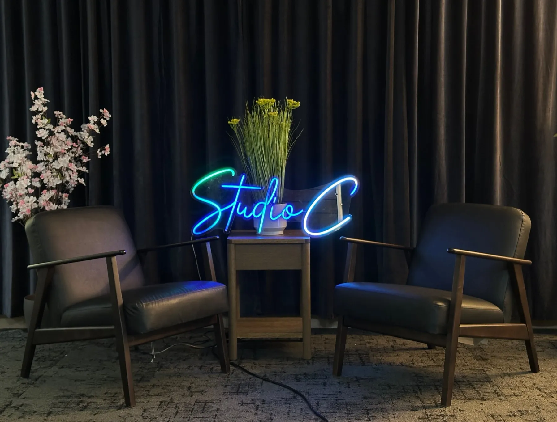 The curtain set at Studio C with the Studio C neon sign